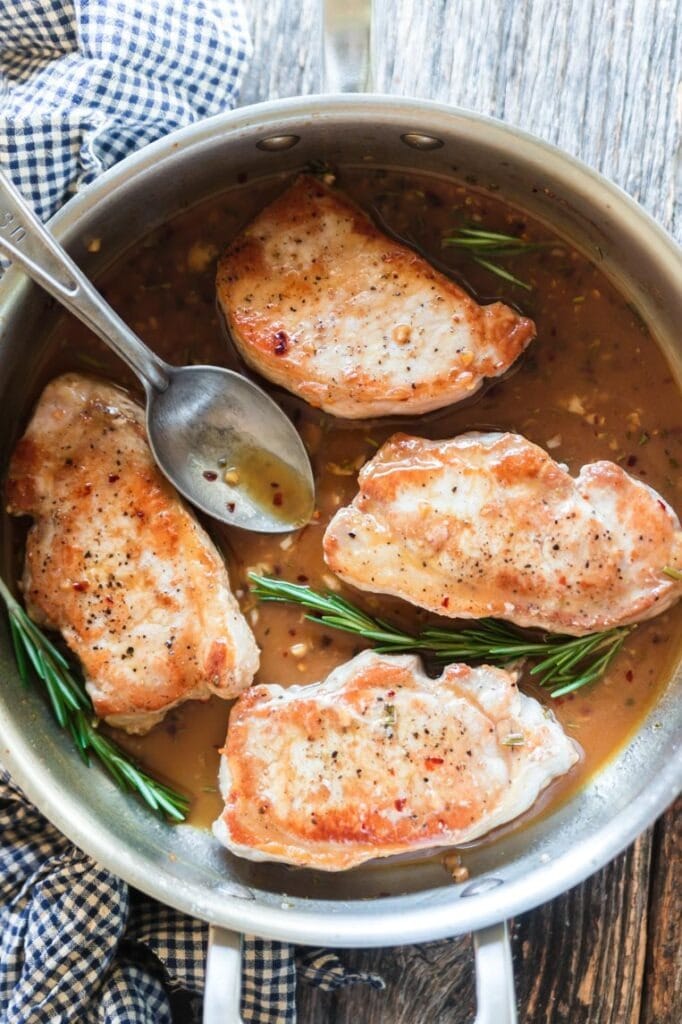 Pork chops cooked in apple cider sauce. 