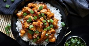 Homemade Glazed Chicken with Rice in a Black Plate