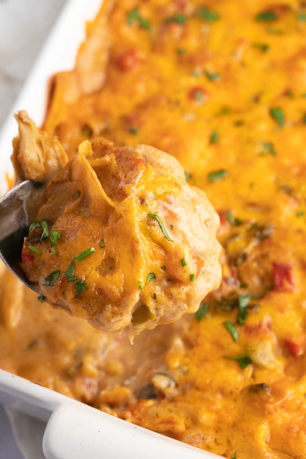 Closeup of A Spoon Scooping Cheesy King Ranch Chicken Casserole