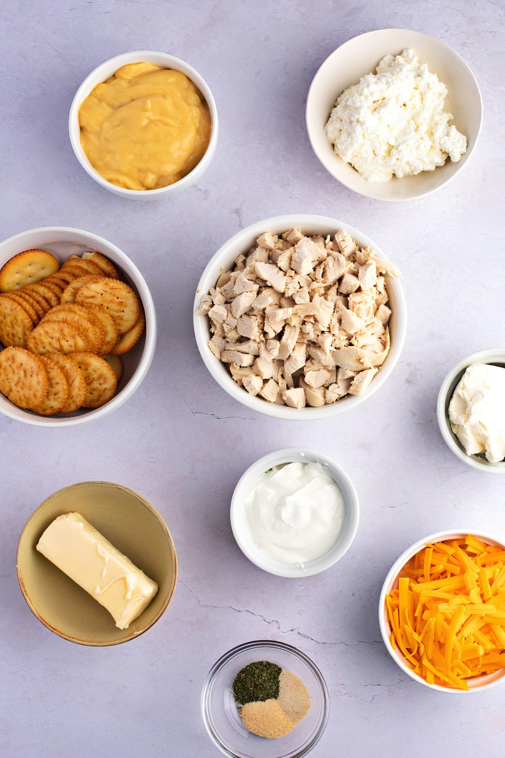 Million Dollar Chicken Casserole Ingredients, Cream of Chicken Soup, Cream Cheese, Ritz Crackers, Cooked Chicken, Grated Cheese, Butter, Seasonings and Cottage Cheese